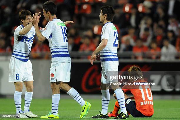 Sho Sasaki of Ventforet Kofu celebrates scoring his team's first goal with his teammate Kohei Morita and Naoaki Aoyama during the J.League match...