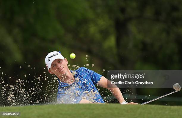 Will Wilcox chips out of the bunker on the 1st Round Three of the Zurich Classic of New Orleans at TPC Louisiana on April 26, 2014 in Avondale,...