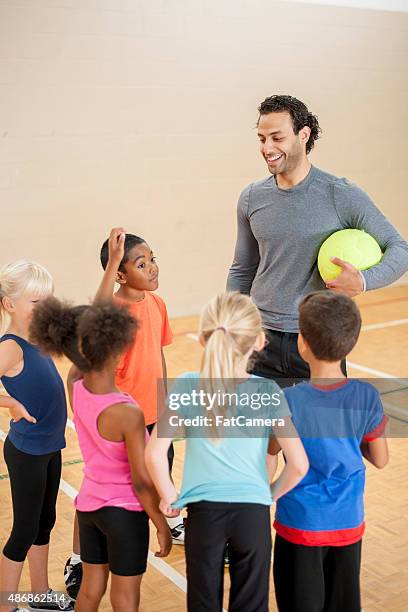 kids listening to their gym coach - physical education stock pictures, royalty-free photos & images
