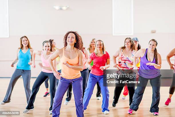 women doing fitness class together - zumba dance stock pictures, royalty-free photos & images