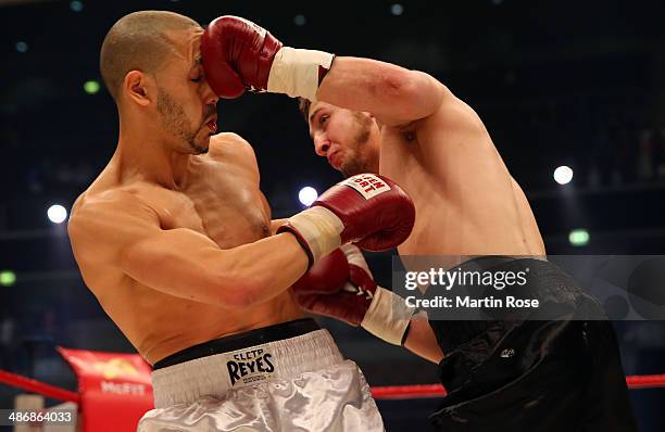 Roman Baleav of Germany exchange punches with Fouad El Massoudi of France during their welterweight fight at Koenig-Pilsner Arena on April 26, 2014...