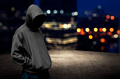 Faceless man in hood on the rooftop