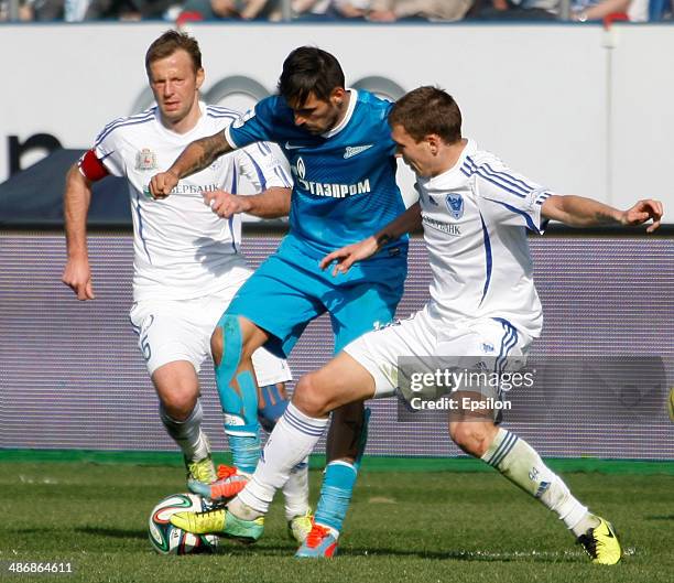 Miguel Danny of FC Zenit St. Petersburg vies for the ball with Andrei Karyaka of FC Volga Nizhny Novgorod and Nikita Chicherin of FC Volga Nizhny...