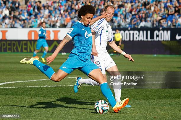 Axel Witsel of FC Zenit St. Petersburg shoots the ball as Piotr Polczak of FC Volga Nizhny Novgorod defends during the Russian Football League...