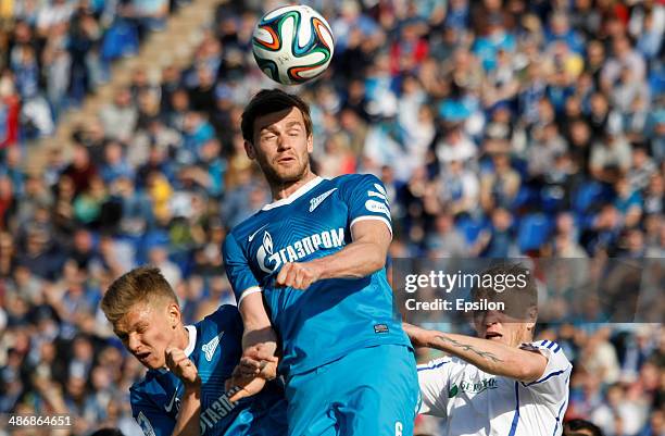 Oleg Shatov of FC Zenit St. Petersburg , Nicolas Lombaerts of FC Zenit St. Petersburg and Denis Kolodin of FC Volga Nizhny Novgorod vie for a header...