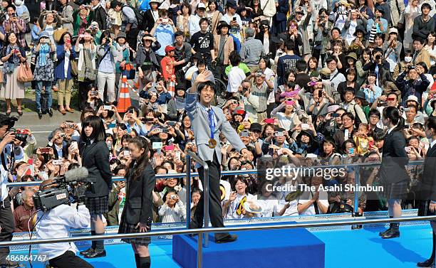 Sochi Olympics figure skating Men's Singles gold medalist Yuzuru Hanyu waves during his gold medal parade on April 26, 2014 in Sendai, Miyagi, Japan....