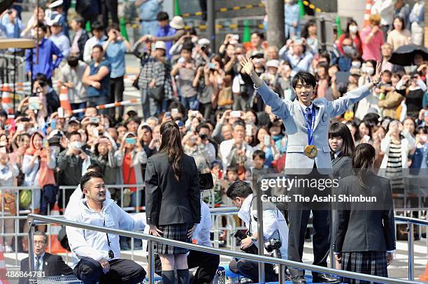 Sochi Olympics figure skating Men's Singles gold medalist Yuzuru Hanyu waves during his gold medal parade on April 26, 2014 in Sendai, Miyagi, Japan....