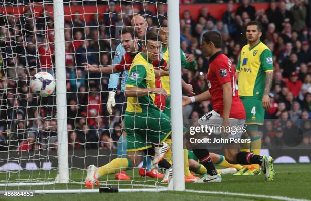 Juan Mata of Manchester United scores their fourth goal during the Barclays Premier League match between Manchester United and Norwich at Old...