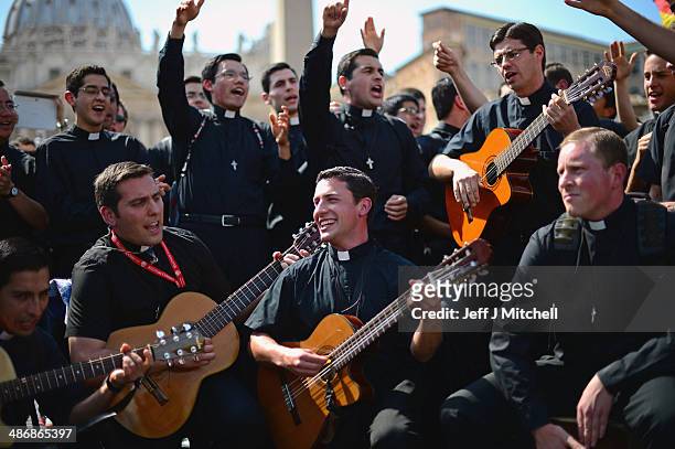 Pilgrims dance and pray as they wait to enter the Basilica in Saint Peter's Square on April 26, 2014 in Vatican City, Vatican. Dignitaries, heads of...