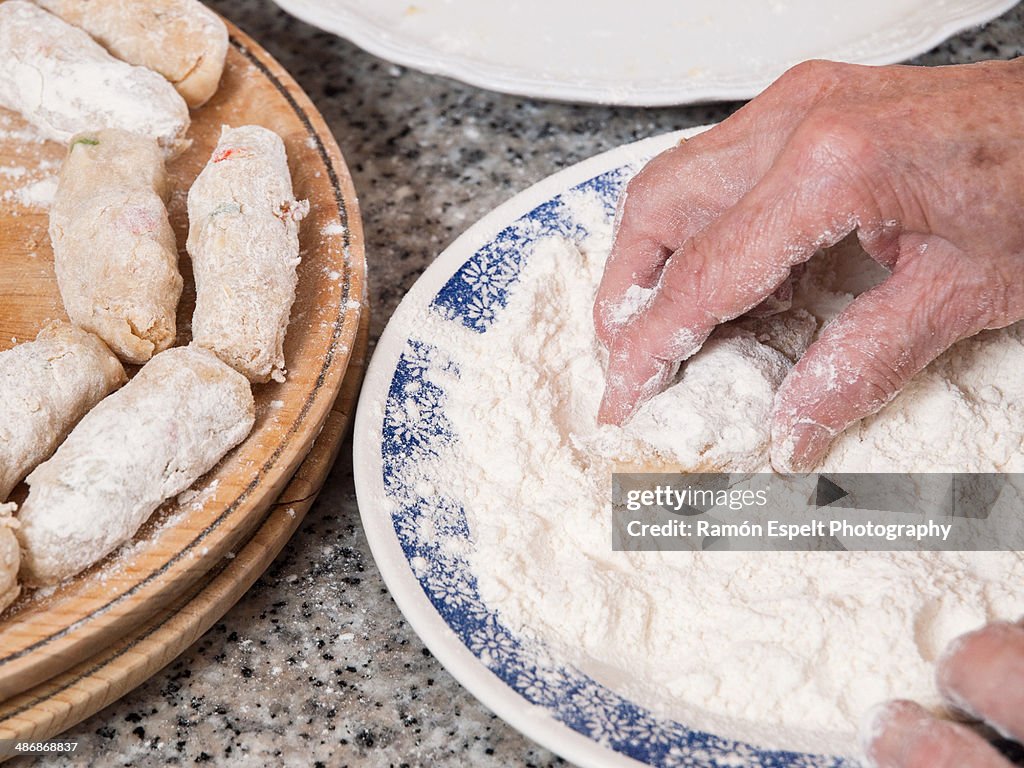 Old hands preparing a homemade croquettes