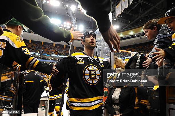 Zdeno Chara of the Boston Bruins high fives fans after warm ups before taking on the Detroit Red Wings in Game Five of the First Round of the 2014...