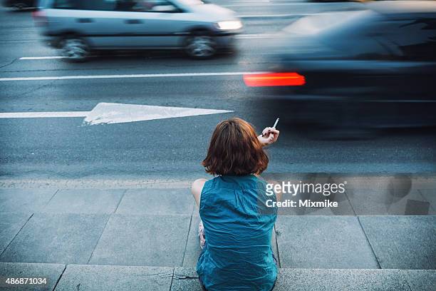 teenager smoking on a sidewalk - exclusion bildbanksfoton och bilder