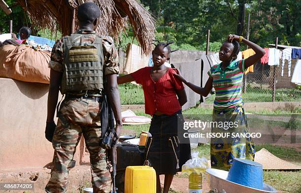 Soldier of the Misca talk to two displaced women in the courtyard of a Catholic church where residents took refuge after an ex-Seleka rebels'...