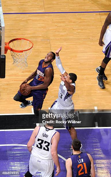 Dionte Christmas of the Phoenix Suns goes up for the shot against Ray McCallum of the Sacramento Kings on April16, 2014 at Sleep Train Arena in...