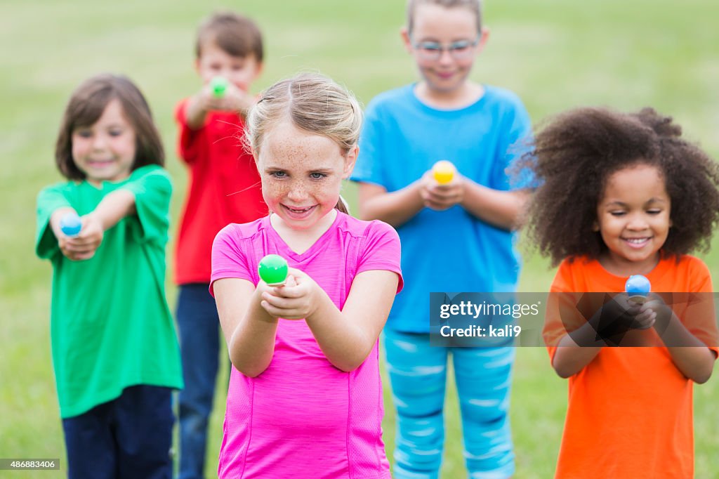 Multiracial group of children in an egg spoon race