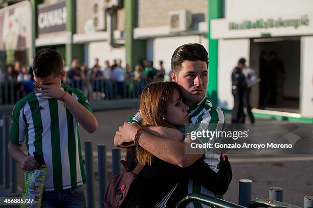 Real Betis Balompie fans embrace waiting the team arrival at Estadio Benito Villamarin outdoors after knowing that their team fall to seond division...