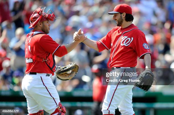 Tanner Roark of the Washington Nationals celebrates with Sandy Leon after pitching a complete game shutout against the San Diego Padres at Nationals...