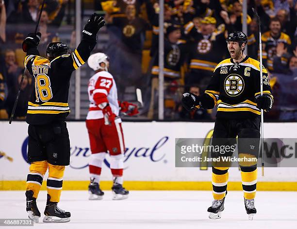 Zdeno Chara of the Boston Bruins celebrates his goal at the end of the second period with teammate Reilly Smith against the Detroit Red Wings in Game...