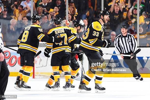 Zdeno Chara of the Boston Bruins celebrate a goal against the Detroit Red Wings in Game Five of the First Round of the 2014 Stanley Cup Playoffs at...