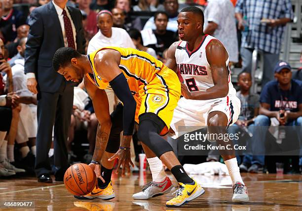 Shelvin Mack of the Atlanta Hawks defends against Paul George of the Indiana Pacers in Game Four of the Eastern Conference Quarterfinals during the...