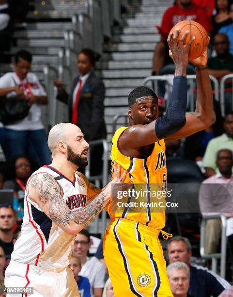 Pero Antic of the Atlanta Hawks defends against Roy Hibbert of the Indiana Pacers in Game Four of the Eastern Conference Quarterfinals during the...