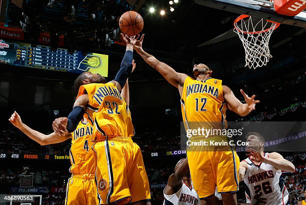 Watson and Evan Turner of the Indiana Pacers grab a rebound against Kyle Korver and Shelvin Mack of the Atlanta Hawks in Game Four of the Eastern...