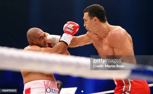 Wladimir Klitschko of Ukraine exchanges punches with Alex Leapai of Australia during their WBO, WBA, IBF and IBO heavy weight title fight between...
