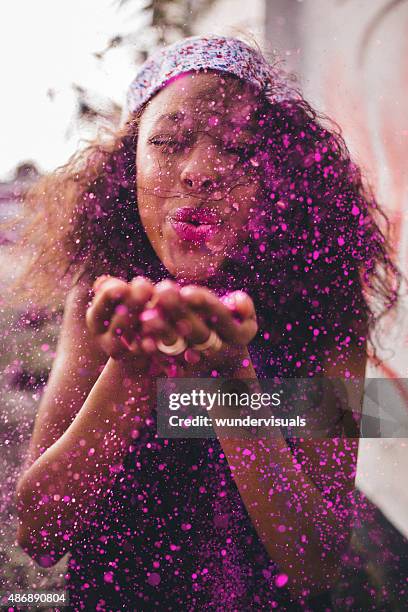 bright pink glitter being blown by a teenage girl - sparkle children stock pictures, royalty-free photos & images
