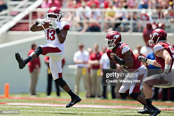 Scotty Thurman of the Arkansas Razorbacks White squad catches a pass in front of Braylon Mitchell of the White squad during the Red White Spring...