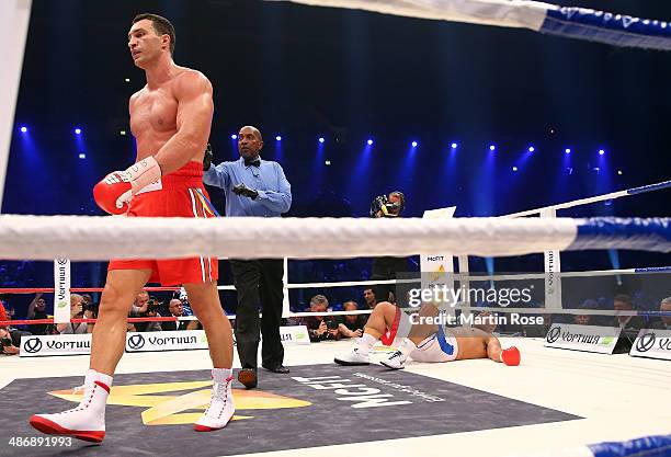 Alex Leapai of Australia lies on the floor after he was knocked down by Wladimir Klitschko of Ukraine during their WBO, WBA, IBF and IBO heavy weight...