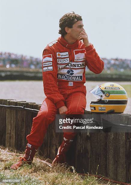 Ayrton Senna of Brazil, driver of the Honda Marlboro McLaren McLaren MP4/5 Honda V10 watches the race after spinning out during the British Grand...