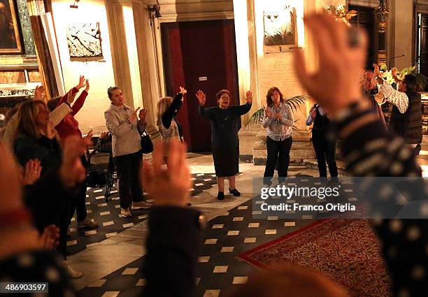 Italian faithful attend a prayer vigil at the Chiesa Degli Artisti were Pope John XXIII celebrated his first mass on April 26, 2014 in Vatican City,...