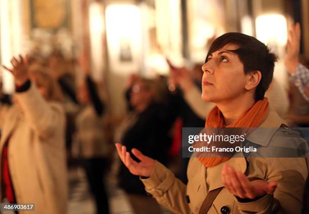 Italian faithful attend a prayer vigil at the Chiesa Degli Artisti were Pope John XXIII celebrated his first mass on April 26, 2014 in Vatican City,...