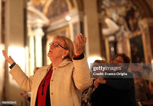 Italian faithful attend a prayer vigil at the Chiesa Degli Artisti were Pope John XXIII celebrated his first mass on April 26, 2014 in Vatican City,...