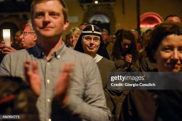 Group of pilgrims attend a Mass celebration in front of the Church of Santa Agense in Agona, at Piazza Navona on April 26, 2014 in Rome, Italy....