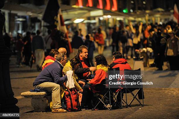 Pilgrims attend a Mass celebration in front of the Church of Santa Agense in Agona, at Piazza Navona on April 26, 2014 in Rome, Italy. Dignitaries,...