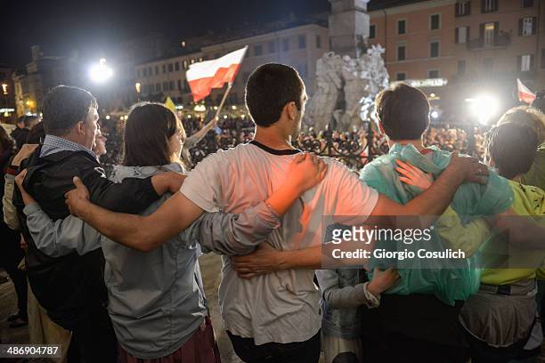 Pilgrims from Poland attend a Mass celebration in front of the Church of Santa Agense in Agona, at Piazza Navona on April 26, 2014 in Rome, Italy....