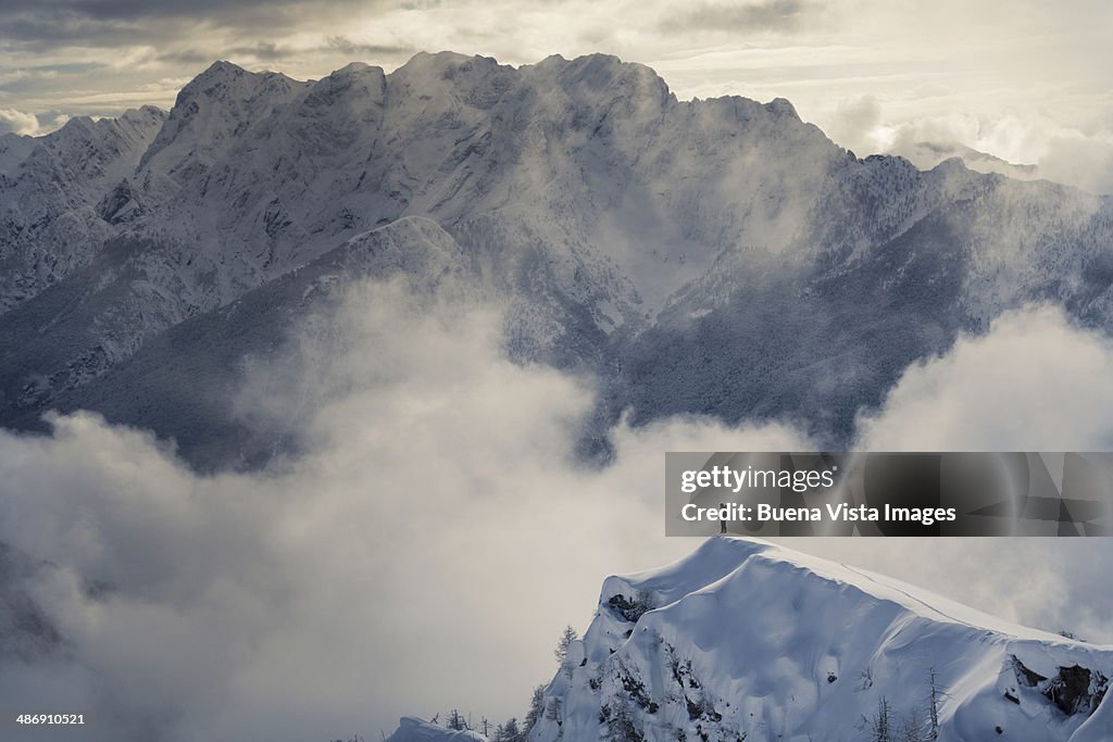 Lone climber standing on a snowy peak