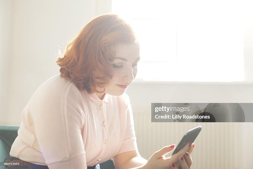 Young woman with vintage style using smartphone