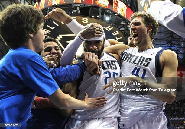 The Dallas Mavericks' Vince Carter and teammate Dirk Nowitzki, right, celebrate following Carter's game-winning three-point shot against the San...