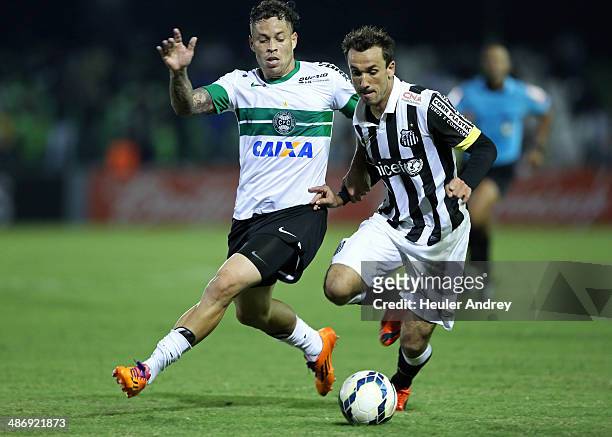 Baraka of Coritiba competes for the ball with Thiago Ribeiro of Santos during the match between Coritiba and Santos for the Brazilian Series A 2014...