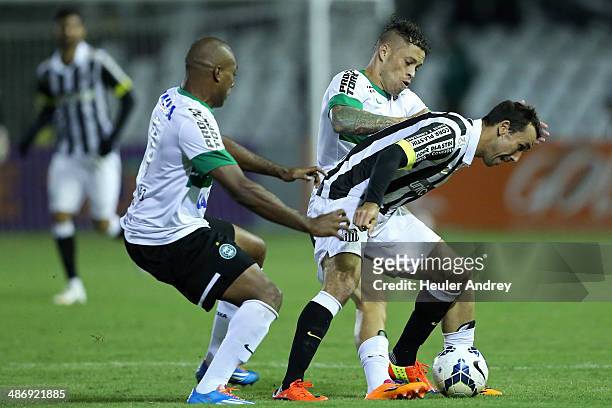 Luccas Claro and Baraka of Coritiba competes for the ball with Thiago Ribeiro of Santos during the match between Coritiba and Santos for the...