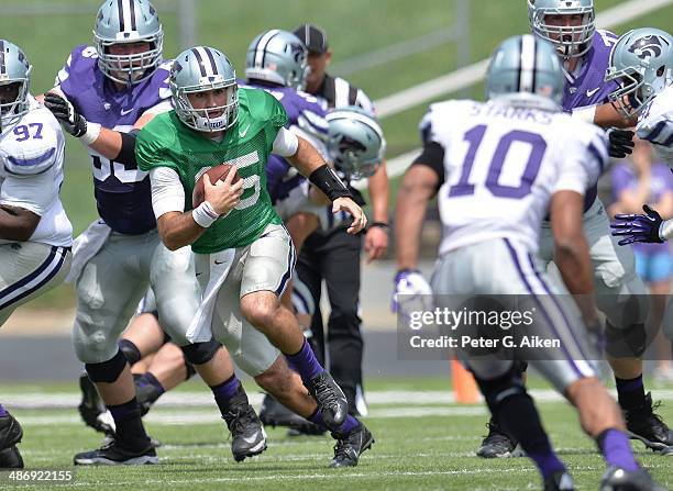 Quarterback Jake Waters of the Kansas State Wildcats rushes down field during the Spring Game on April 26, 2014 at Bill Snyder Family Stadium in...