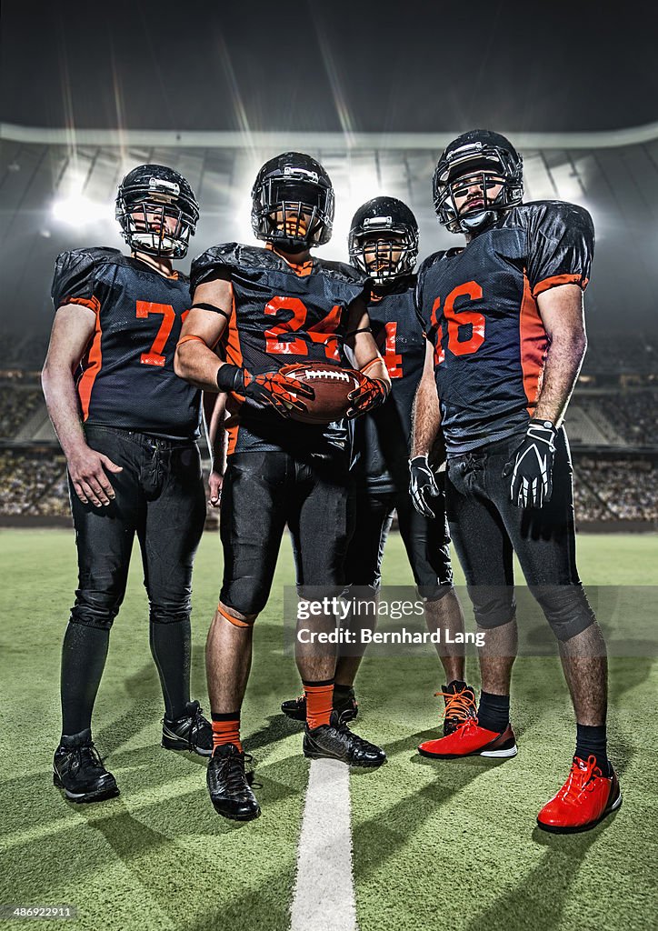 American Football players standing in a stadium