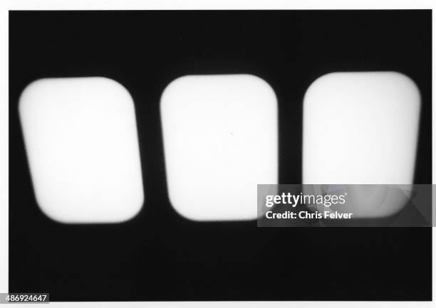 Abstract image of three, light-colored oval shapes seen against a dark background, 2006. From The Ordered World series.