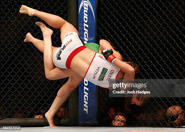 Jessamyn Duke attempts to throw Bethe Correia with a judo toss in their women's bantamweight bout during the UFC 172 event at the Baltimore Arena on...