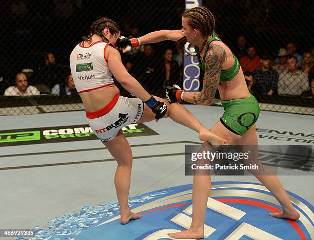 Jessamyn Duke and Bethe Correia trade strikes in their women's bantamweight bout during the UFC 172 event at the Baltimore Arena on April 26, 2014 in...