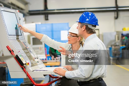Manager And Engineer Programming A CNC Manager And Engineer Programming A CNC