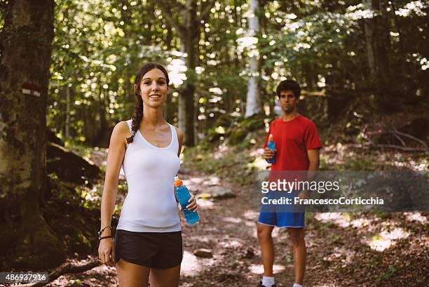 two people pose on a trail - sports drink stock pictures, royalty-free photos & images