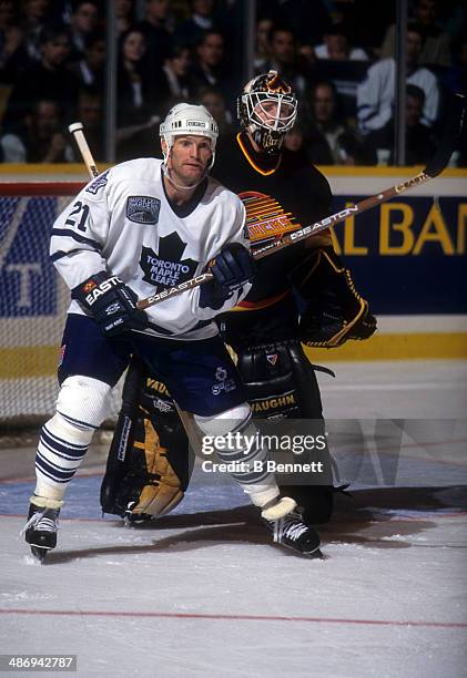 Kirk Muller of the Toronto Maple Leafs screens goalie Corey Hirsch of the Vancouver Canucks on November 26, 1996 at the Maple Leaf Gardens in...